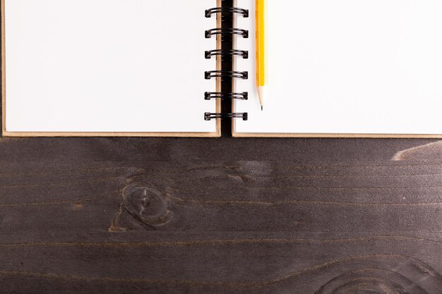 Top view of opened notebook on wooden background