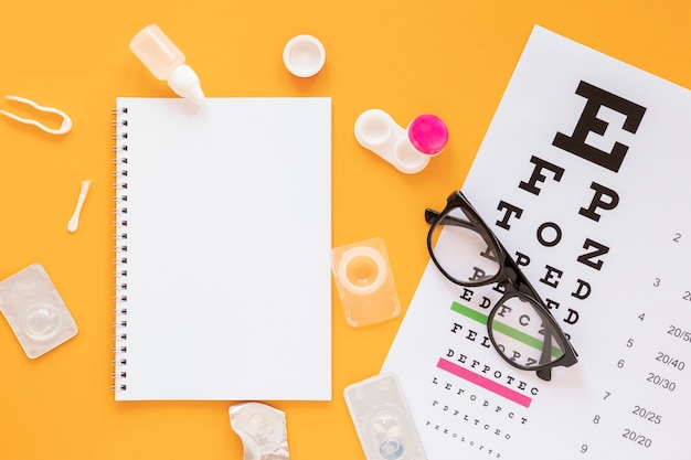 Top view optical consultation products with notebook mock-up