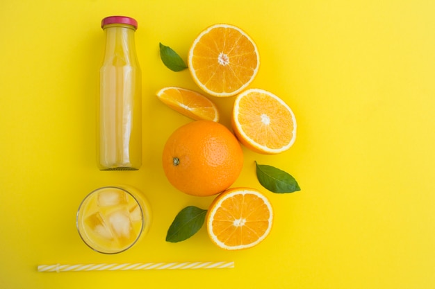 Top view of orange juce and oranges