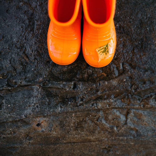 Top view of orange rubber boots.