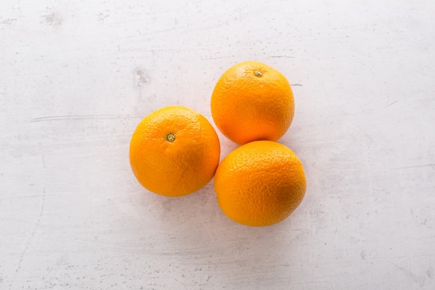 Top of view orange on white concrete board.