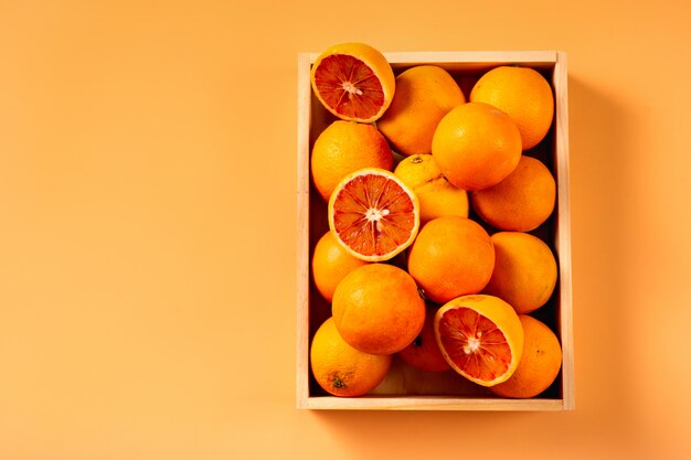 Top view of oranges in a wooden box