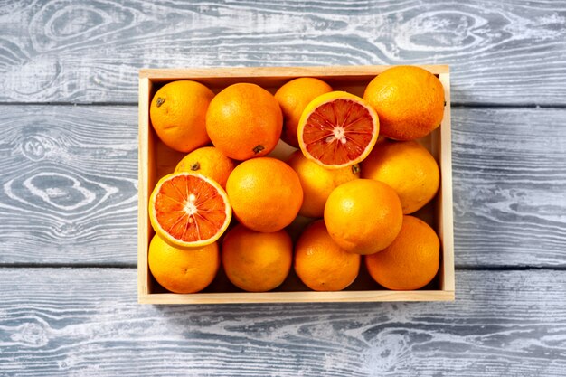 Top view of oranges in a wooden box 