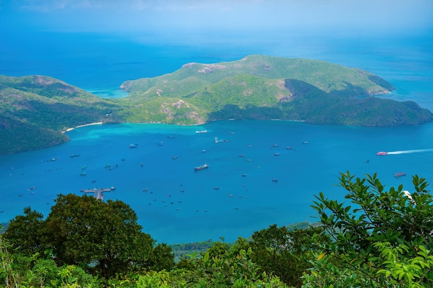 Top view panoramic coastal con dao island view from above with waves coastline clear sky and road blue sea and mountain new passenger port of con dao