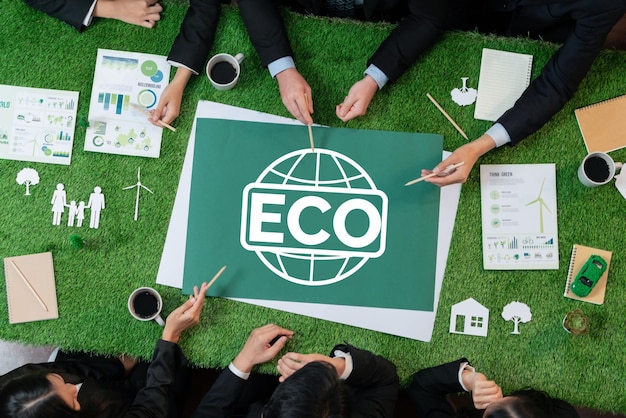 Top view panoramic ECO symbol on green grass table with business people planning for alternative energy utilization for greener sustainable Earth as corporate social responsibility Quaint