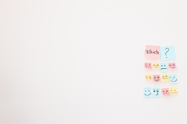 Top view of paper cards with various smileys on white background