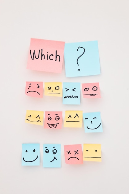 Top view of paper cards with various smileys on white background