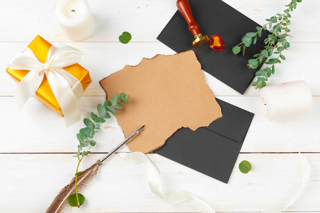 Top view of paper and envelopes with giftbox and branches