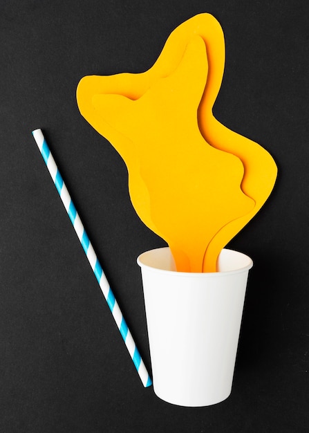 Top view of paper juice spilling with paper cup and straw