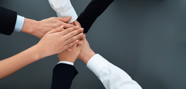 Top view partial hand join stack and form circle as symbol of harmony in office