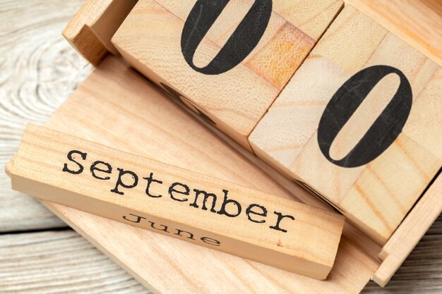 Top view of parts of wooden calendar on dark wooden tabletop