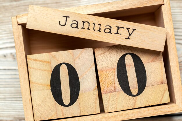 top view of parts of wooden calendar on dark wooden tabletop