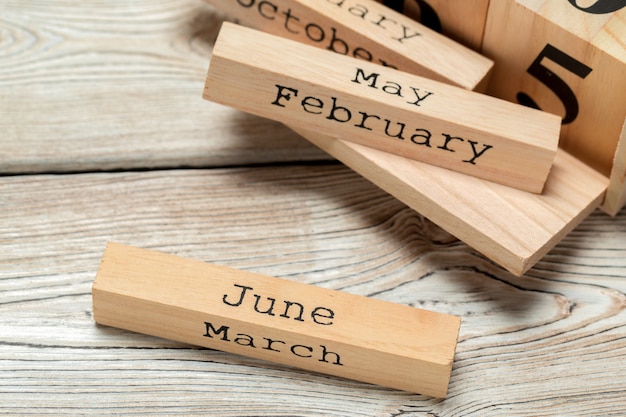 top view of parts of wooden calendar on dark wooden tabletop