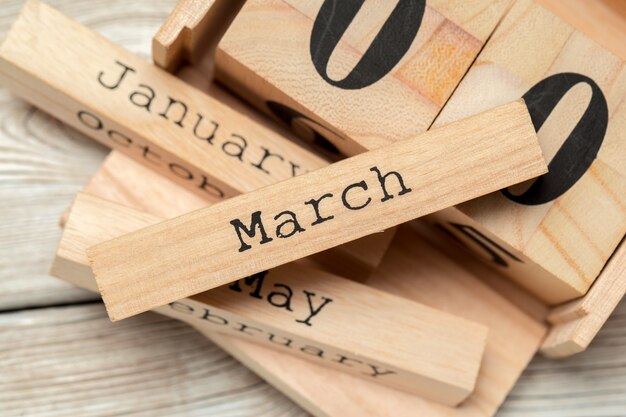 top view of parts of wooden calendar on dark wooden tabletop