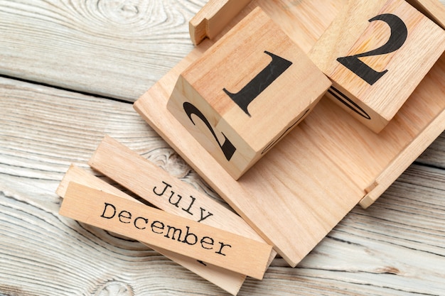 top view of parts of wooden calendar on dark wooden tabletop