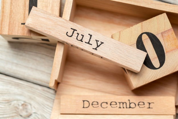 top view of parts of wooden calendar on dark wooden tabletop