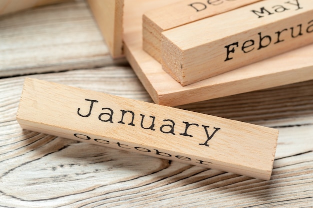 top view of parts of wooden calendar on dark wooden tabletop