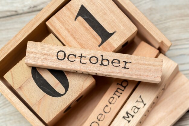 Top view of parts of wooden calendar on dark wooden tabletop