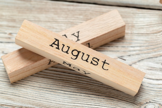 Top view of parts of wooden surface calendar on dark wooden surface tabletop