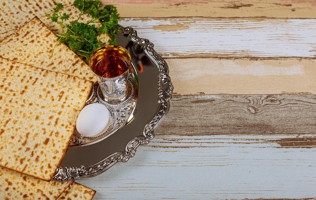 Top view of passover background matzoh jewish holiday bread and traditional sedder plate