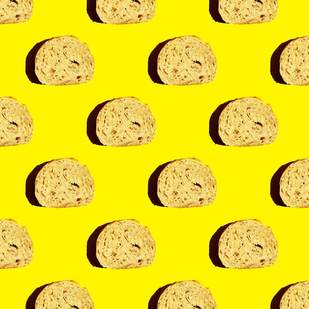 Top view of the pattern of a piece of cut bread on a yellow background morning food