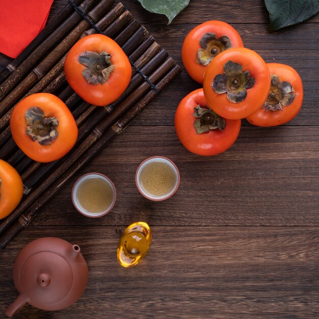 Top view of persimmons on wooden table background for Chinese new year