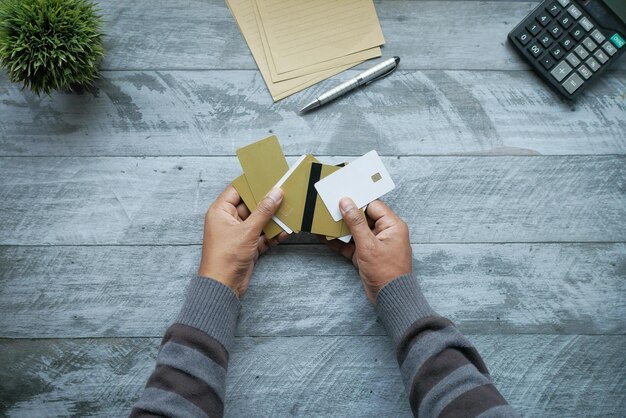 Top view of person hand holding many credit cards