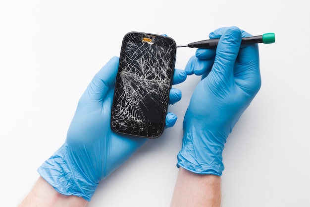 Top view person repairing a smartphone