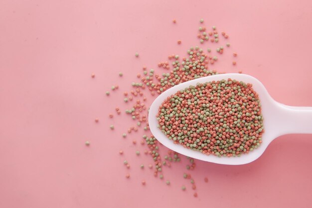 Top view of pet fish food in a spoon