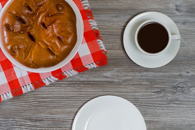 Top view photo of pie cup of drinking and empty plate on wooden table