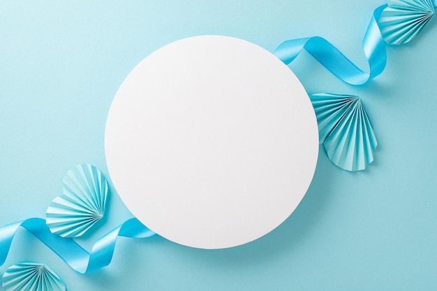 top view photo of white empty circle with a pastel blue ribbon and origami paper hearts on an isolated light blue background with copyspace
