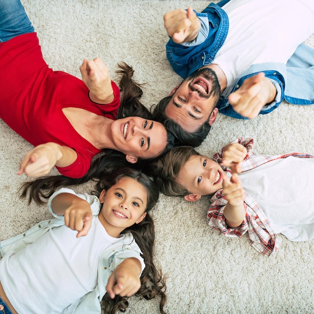 Top view photo of young happy family lying on the floor, have a fun and smiling