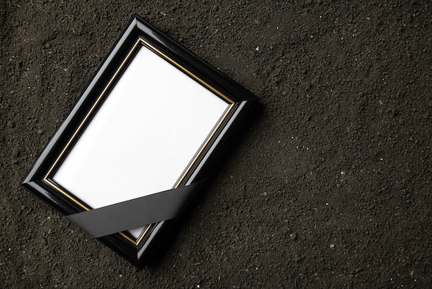 Top view of picture frame on the dark soil