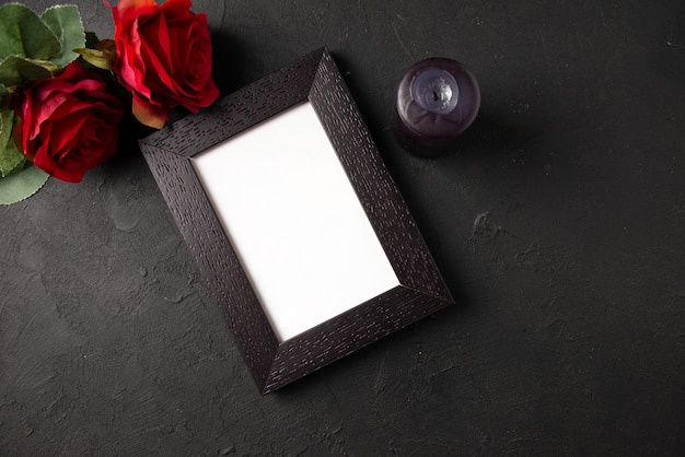 Top view of picture frame with red flowers on dark wall