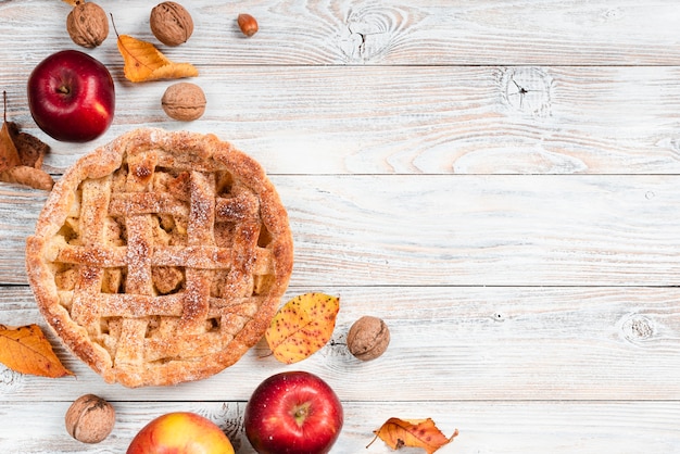 Top view of pie surrounded by apples