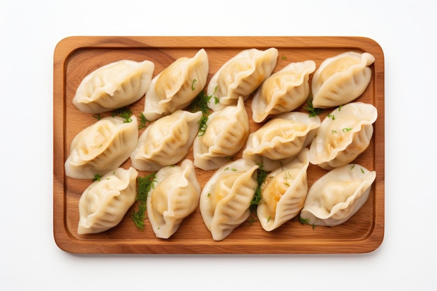 Photo top view pierogi on a wooden boardon white background