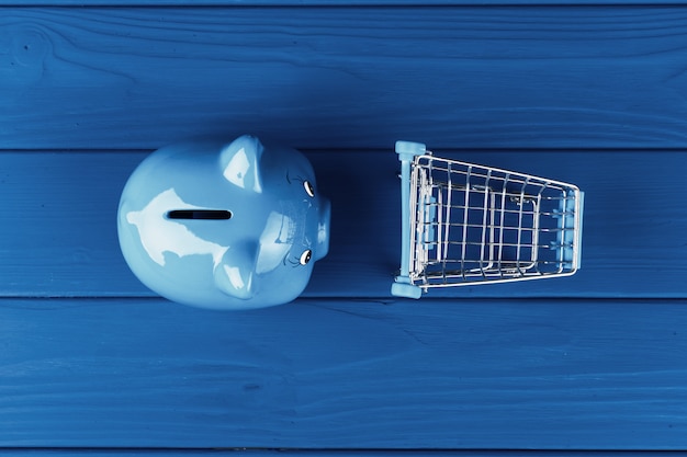 Top view of a piggy bank on classic blue color