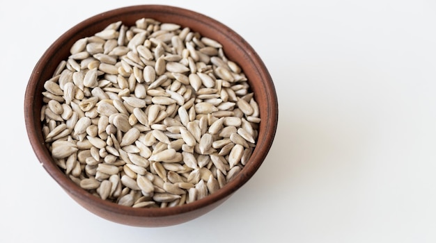 Top view of a pile of natural organic sunflower seeds isolated on white background