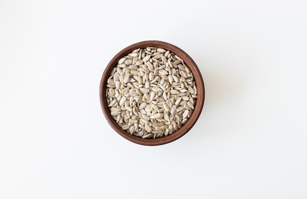 Top view of a pile of natural organic sunflower seeds isolated on white background