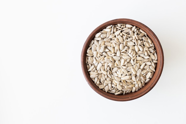 Top view of a pile of natural organic sunflower seeds isolated on white background