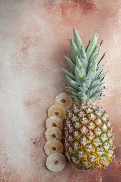 top view pineapple fruit laying down dry pineapple rings on table