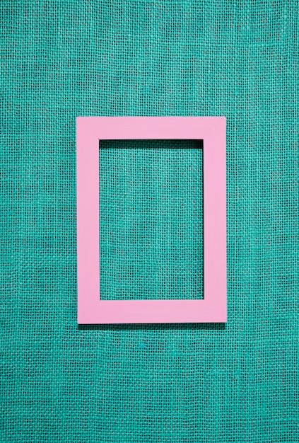 Top view pink frame on green background