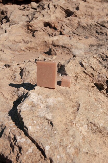 Top view of pink french clay soap bar at the beach