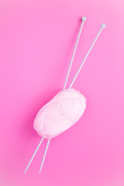 Top view of pink knitting and knitting needles