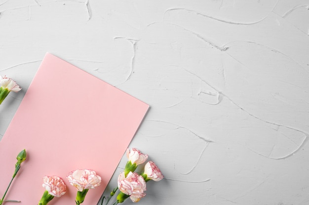 Top view of a pink paper letter and flowers with copy space