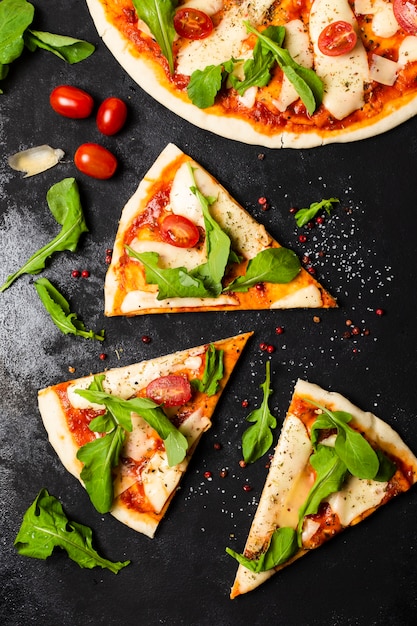 Top view of pizza on black slate table