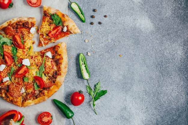 top view of pizza on gray background