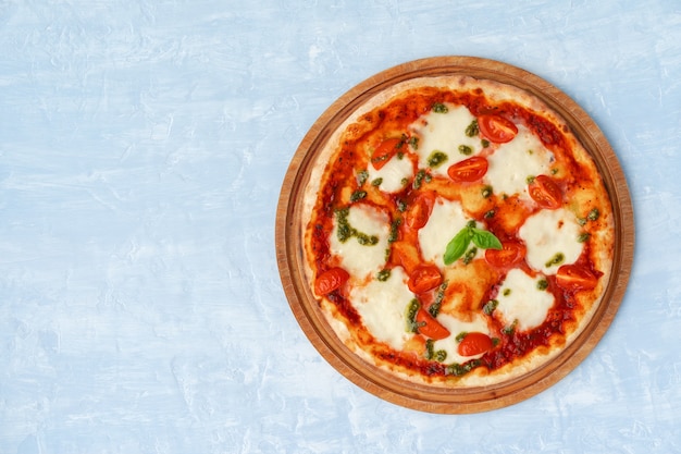 Top view of pizza Margherita on gray surface table