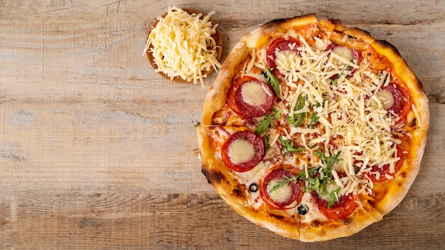 top view pizza with wooden background