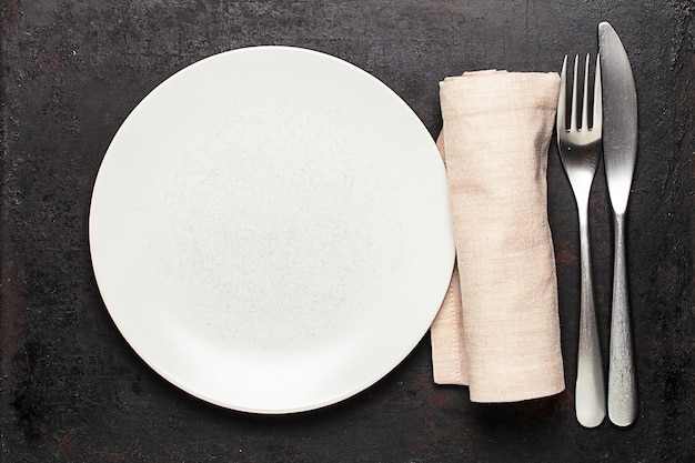 Top view on plate and silverware placed on old rustic